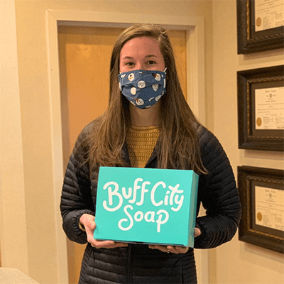 Prize winner holding Buff City Soap gift set