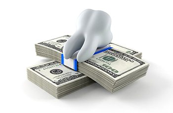 tooth sitting on a pile of money
