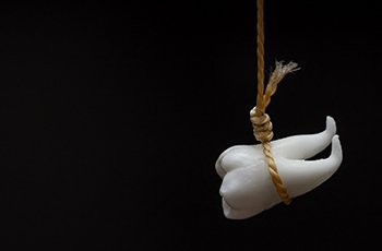 Wisdom tooth hanging from a rope