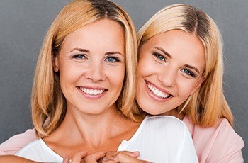 Mother and daughter smiling together after wisdom tooth extractions