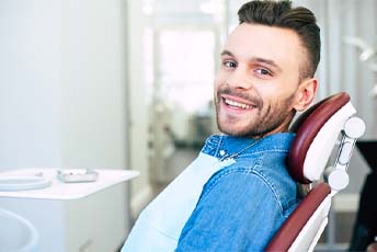 Man smiling after wisdom teeth extractions in Columbia