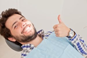 Man with thumbs up in dentist’s chair