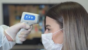 Patient undergoing temperature check from Columbia dentist in COVID-19