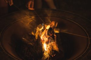 roasting marshmallows over firepit from dentist in Columbia