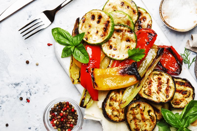 a table complete with summer foods in Columbia that consist of grilled vegetables