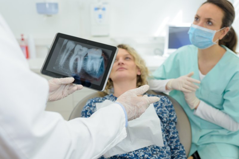 Dentist speaking with a dental implant candidate in Columbia