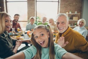 mature man enjoying thanksgiving meal with family