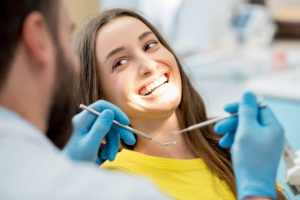 a teenager smiling and visiting the dentist 