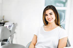 Female dental patient sitting and smiling