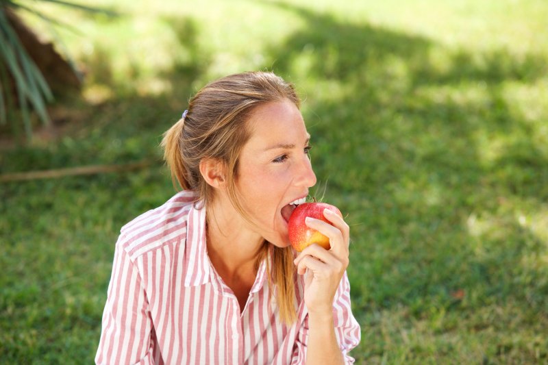 Someone eating an apple