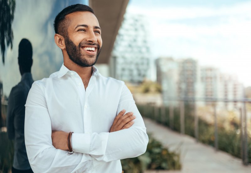 A man smiling with his new dental veneers