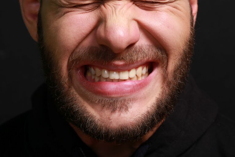 A man grinding his teeth
