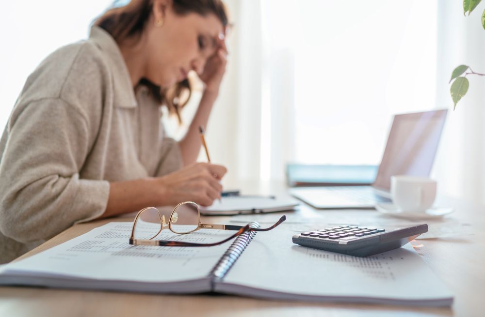 A woman struggling to stay awake at her desk